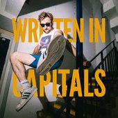 WRITTEN IN CAPITALS