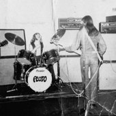 Pluto-onstage-at-NottinghamFrom-left-to-right-Alan-Warner-Lead-Guitar-vocals-Derek-Jervis-Drums-Mick-Worth-Bass-Guitar-Paul-Gardner-Lead-GuitarVocals-768x470.jpg